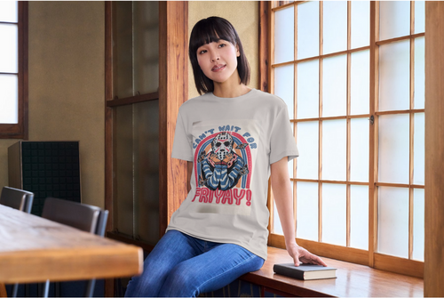 Person wearing a t-shirt with a colorful graphic design in a room with large windows.