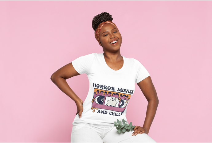 Woman wearing a white t-shirt with colorful graphic design on a pink background